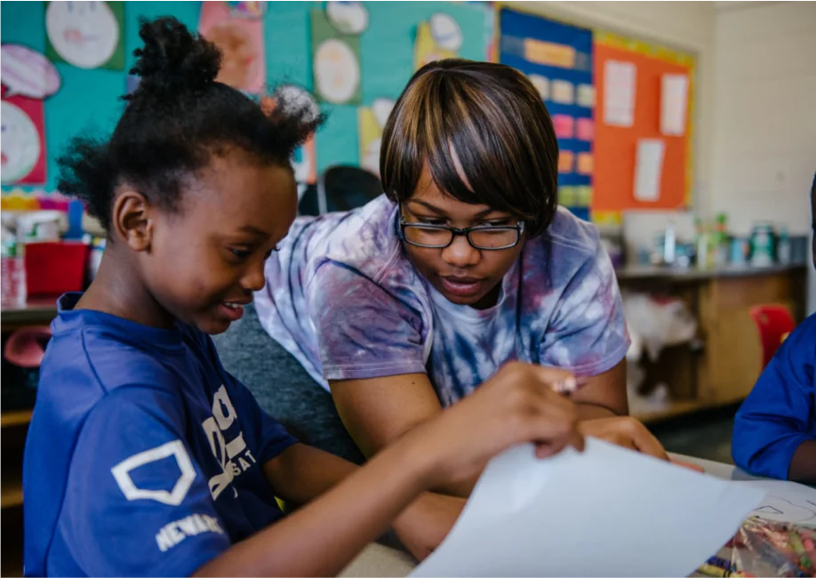 student and teacher working together